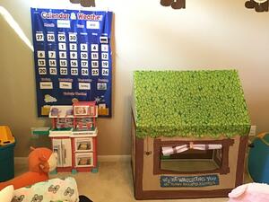 Image of an indoor play house and calendar