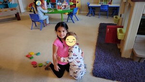 Two children posing, one playing