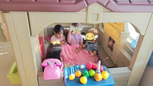 Four children playing in indoor playhouse